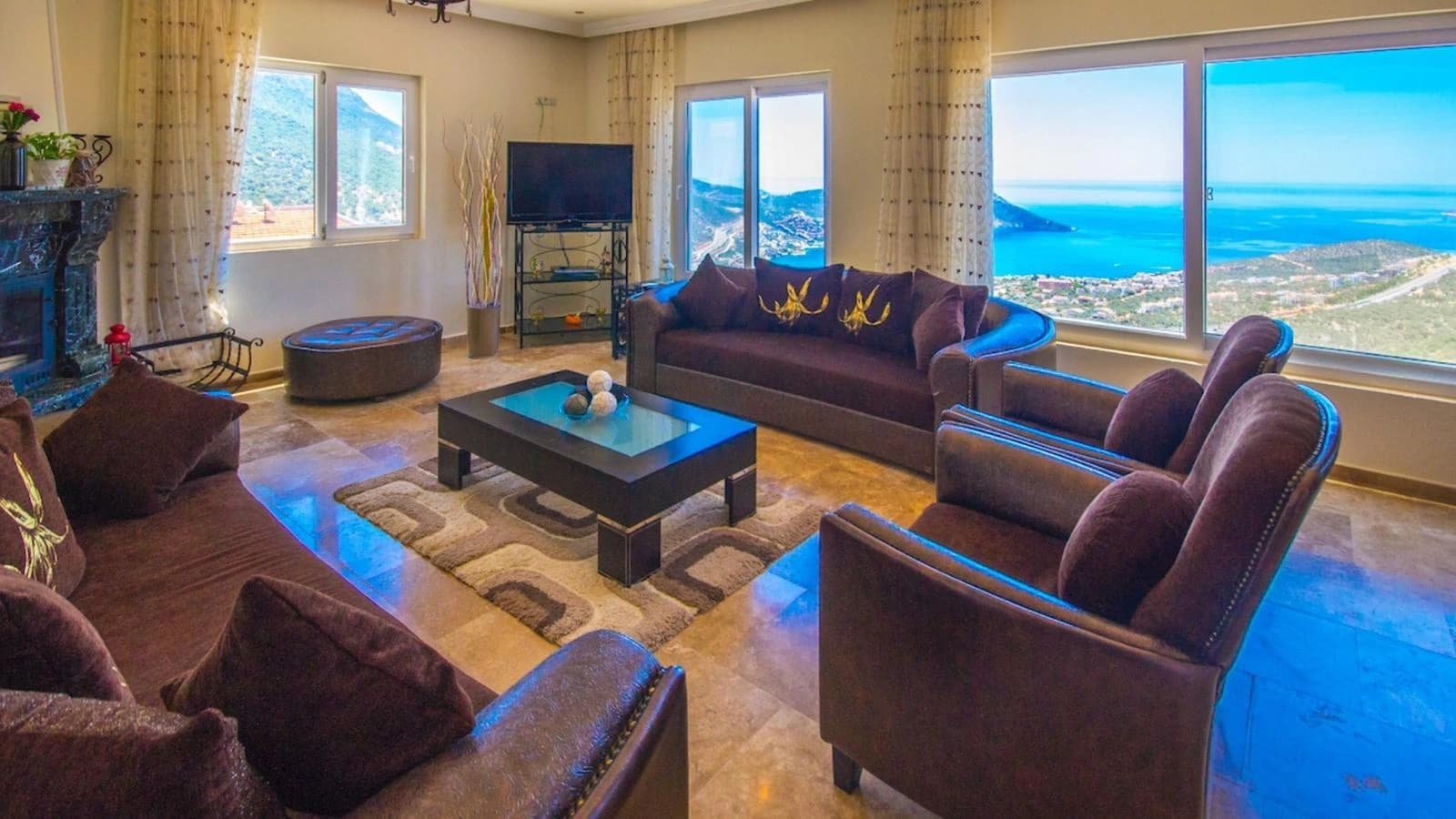Luxurious living room with panoramic Mediterranean sea views and designer furnishings.