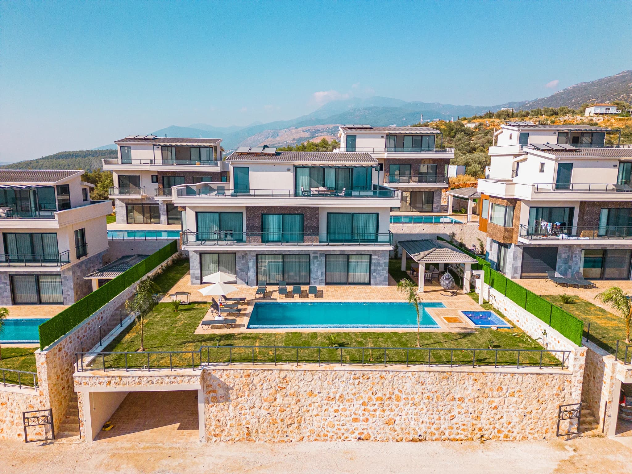 Aerial view of the villa's private pool and terrace with mountain backdrop.