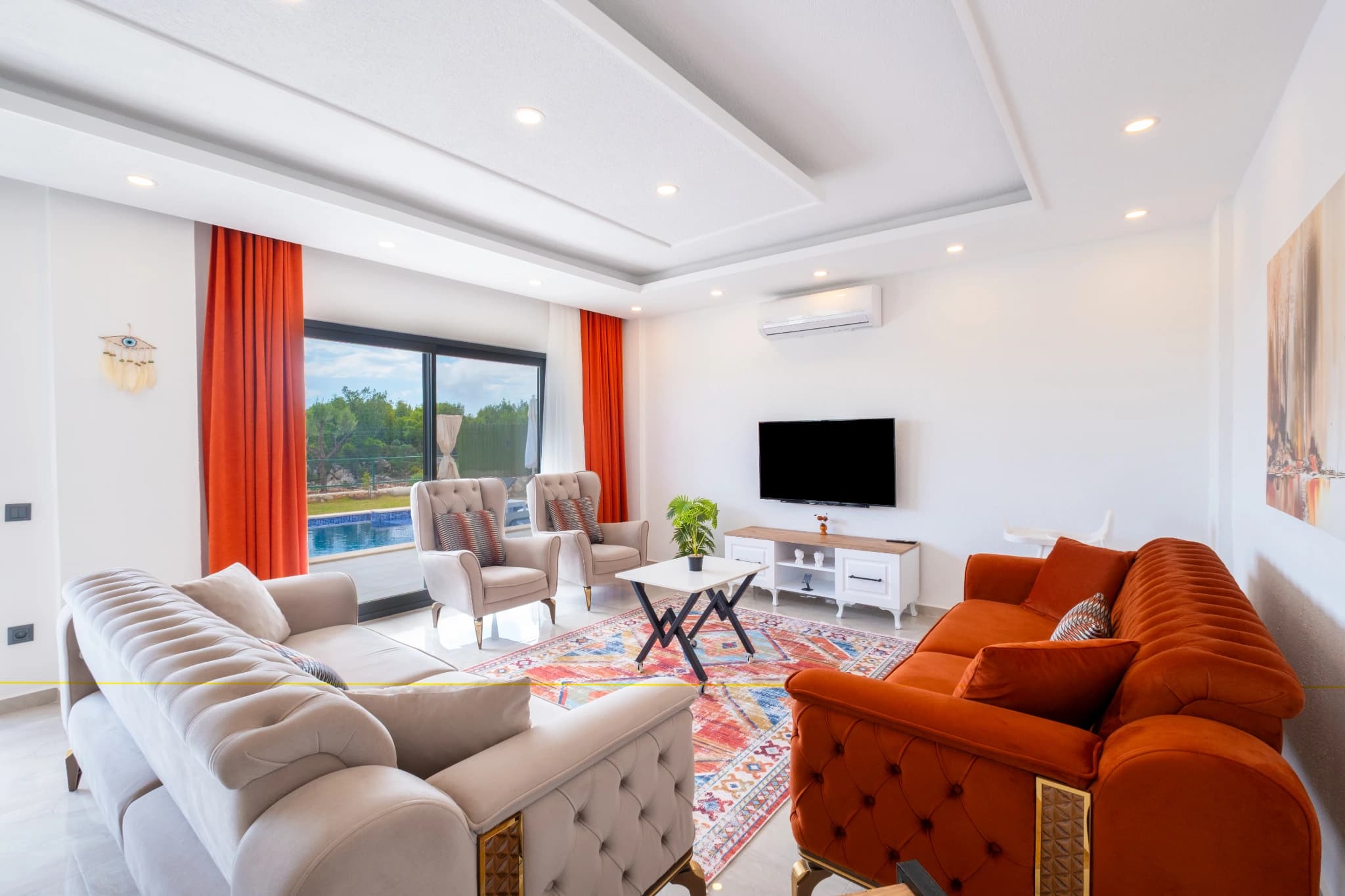 Spacious modern living room with pool-view balcony and comfortable seating.