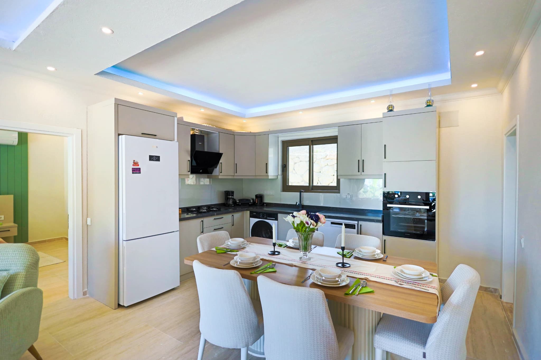 Modern kitchen with full appliances and integrated dining area.