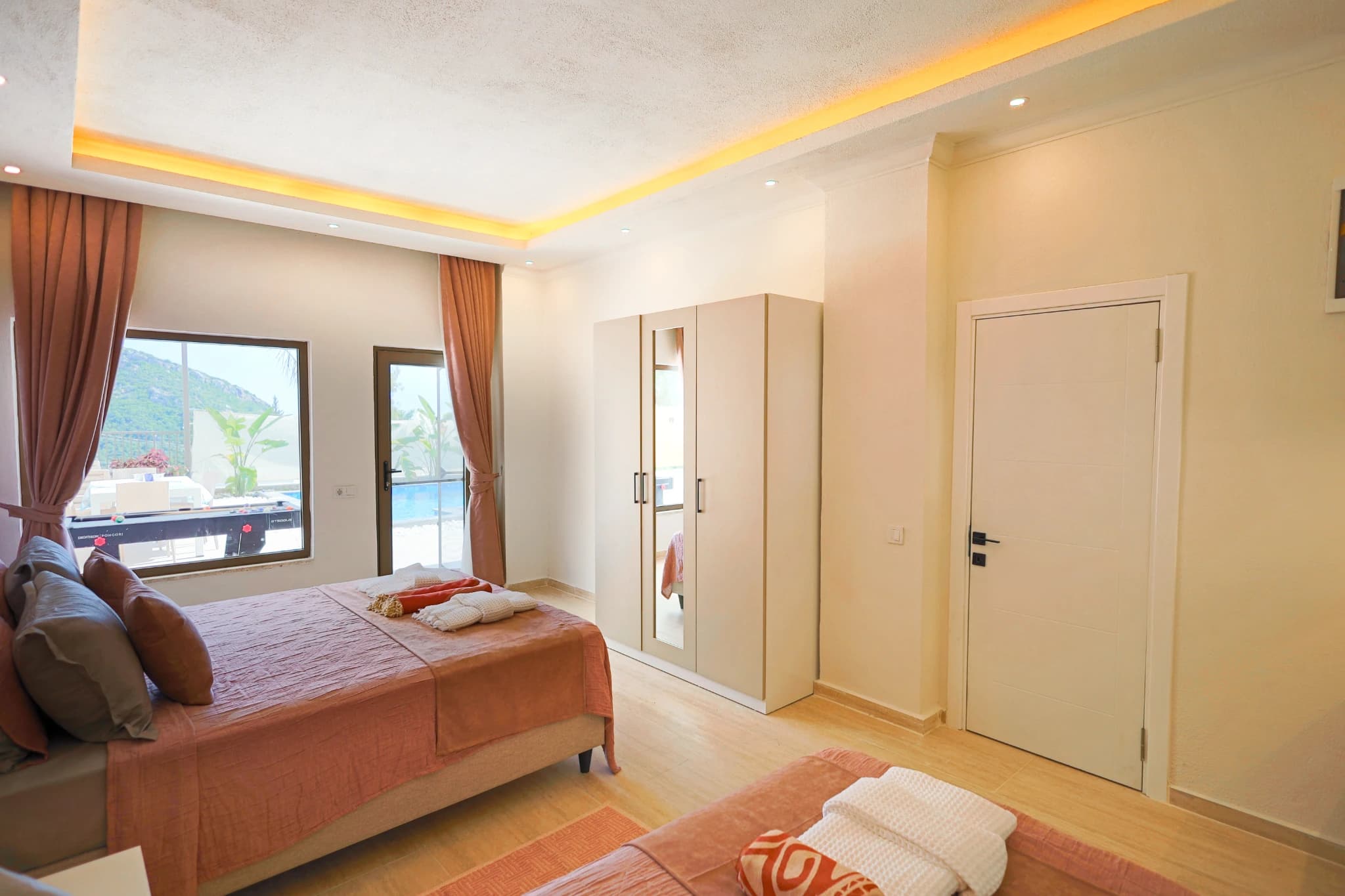 Master bedroom with mountain views, balcony access, and elegant furnishings.