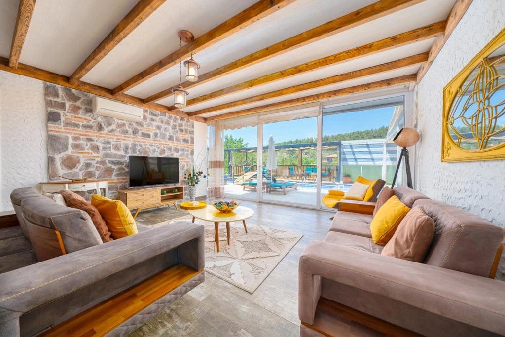 Modern living room with dual sofas, fireplace, and seamless indoor-outdoor flow to terrace.