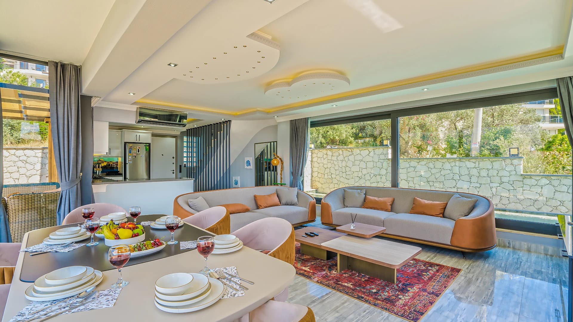 Contemporary living and dining space with integrated kitchen and scenic garden views.