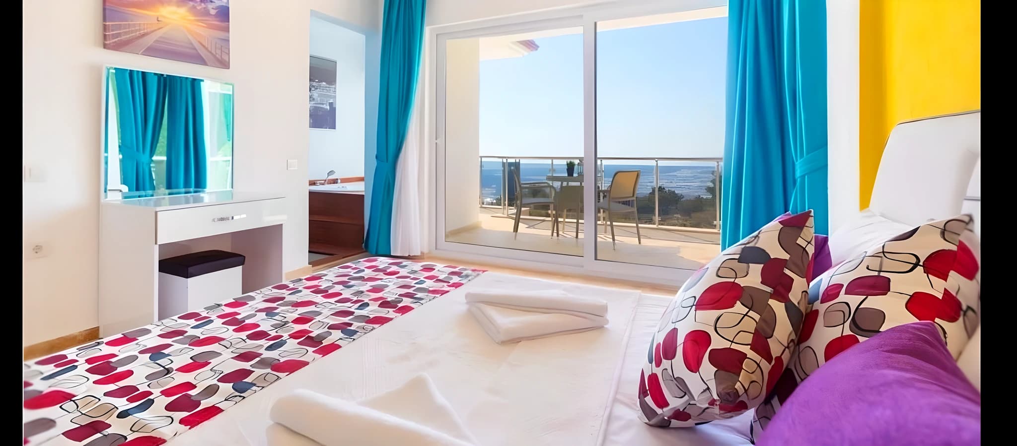 Bright twin-bed bedroom with expansive sea vistas, private balcony, and stylish furnishings.