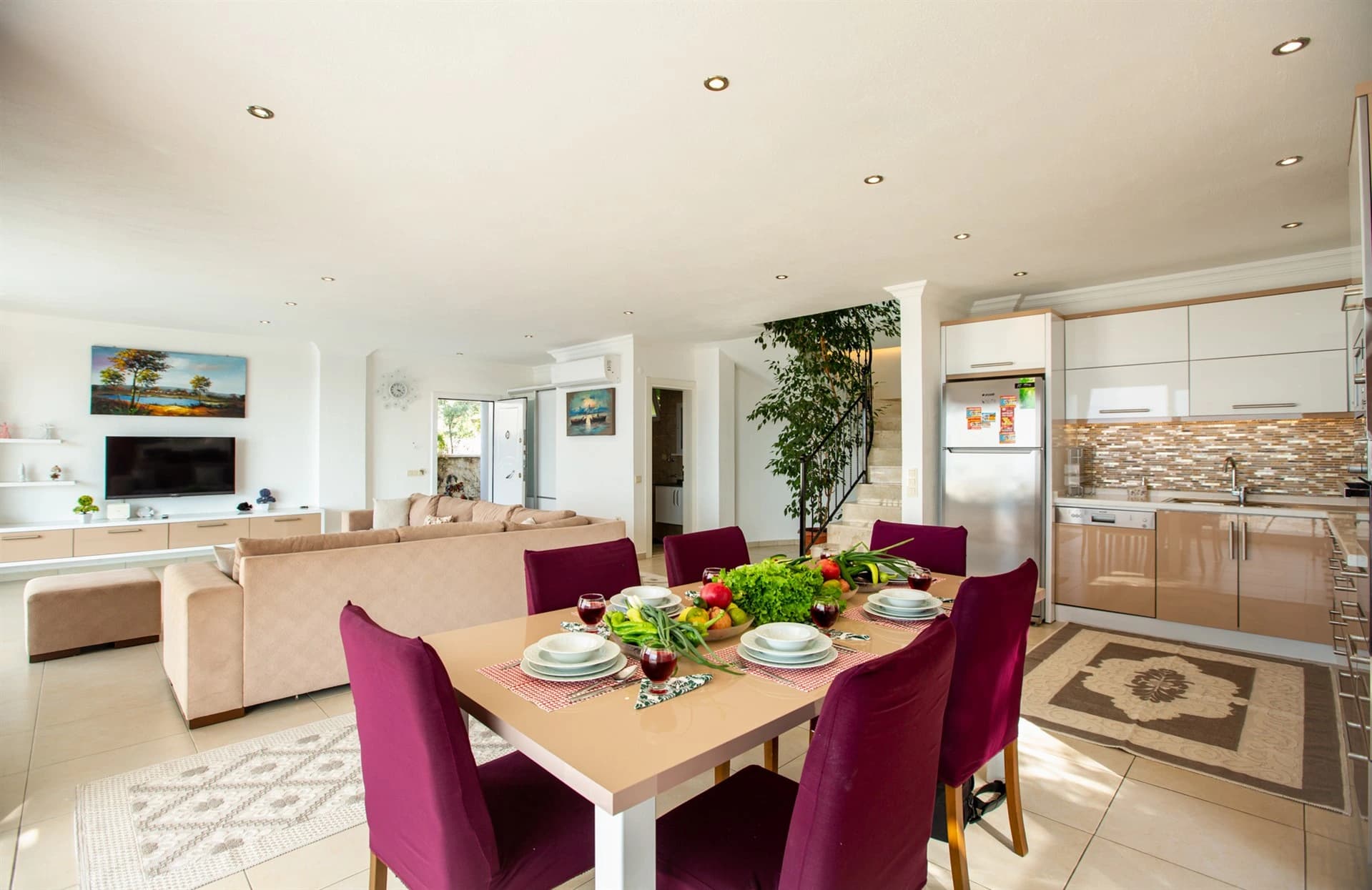 Dining area with open view to kitchen and living room in spacious villa layout.