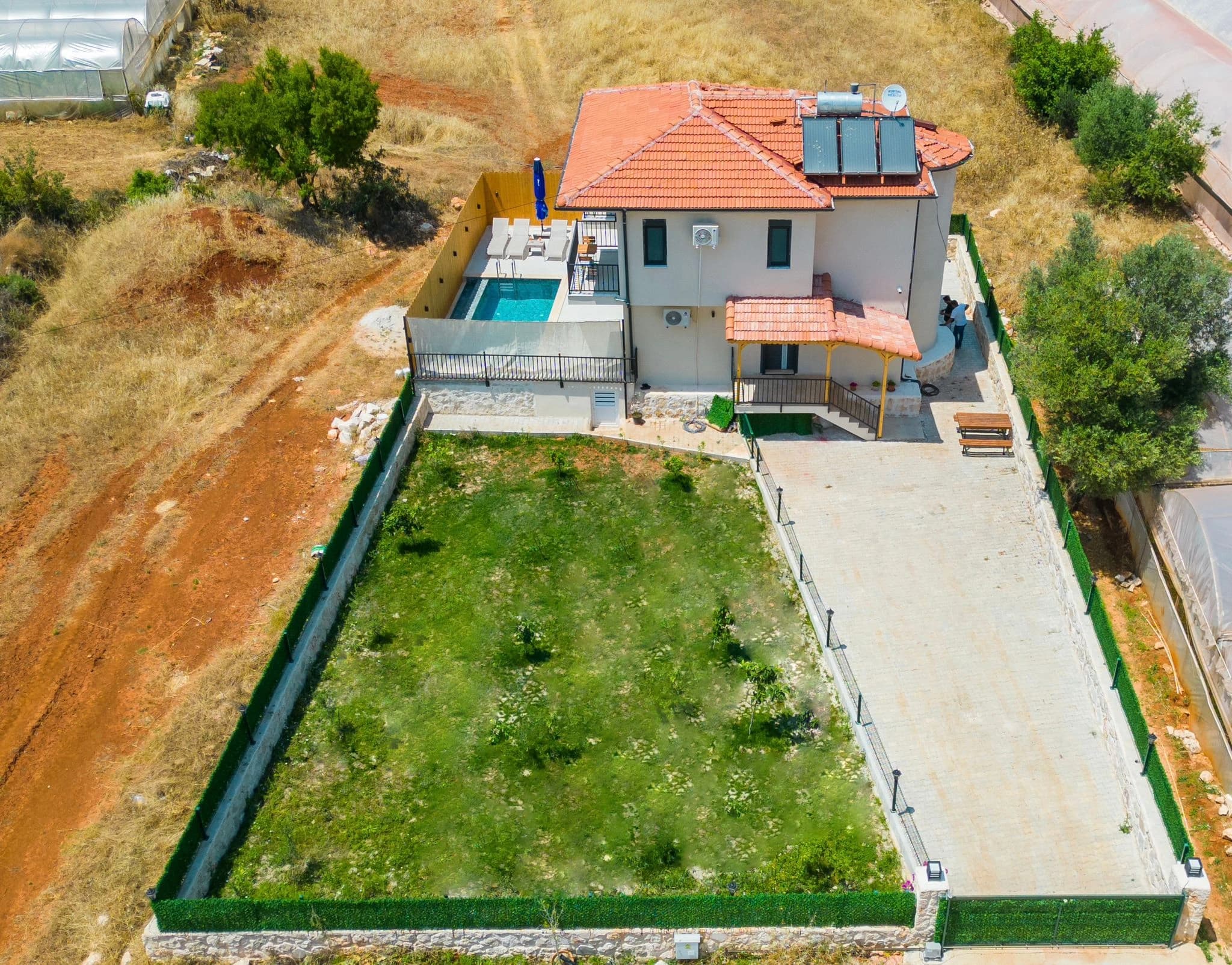 Aerial view of the villa showing the full property layout with garden and pool area.
