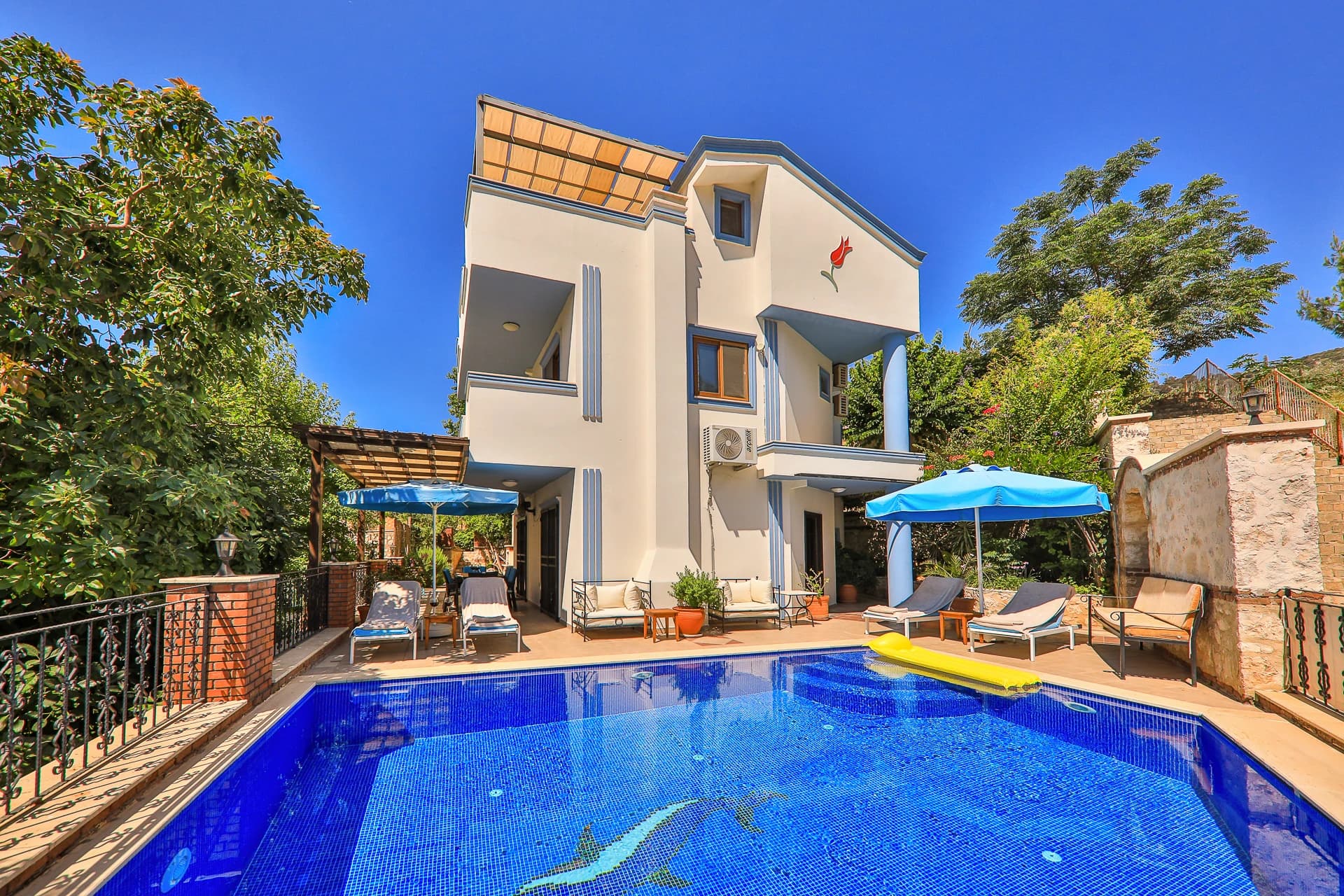 Stunning private pool with sun loungers and mountain backdrop.
