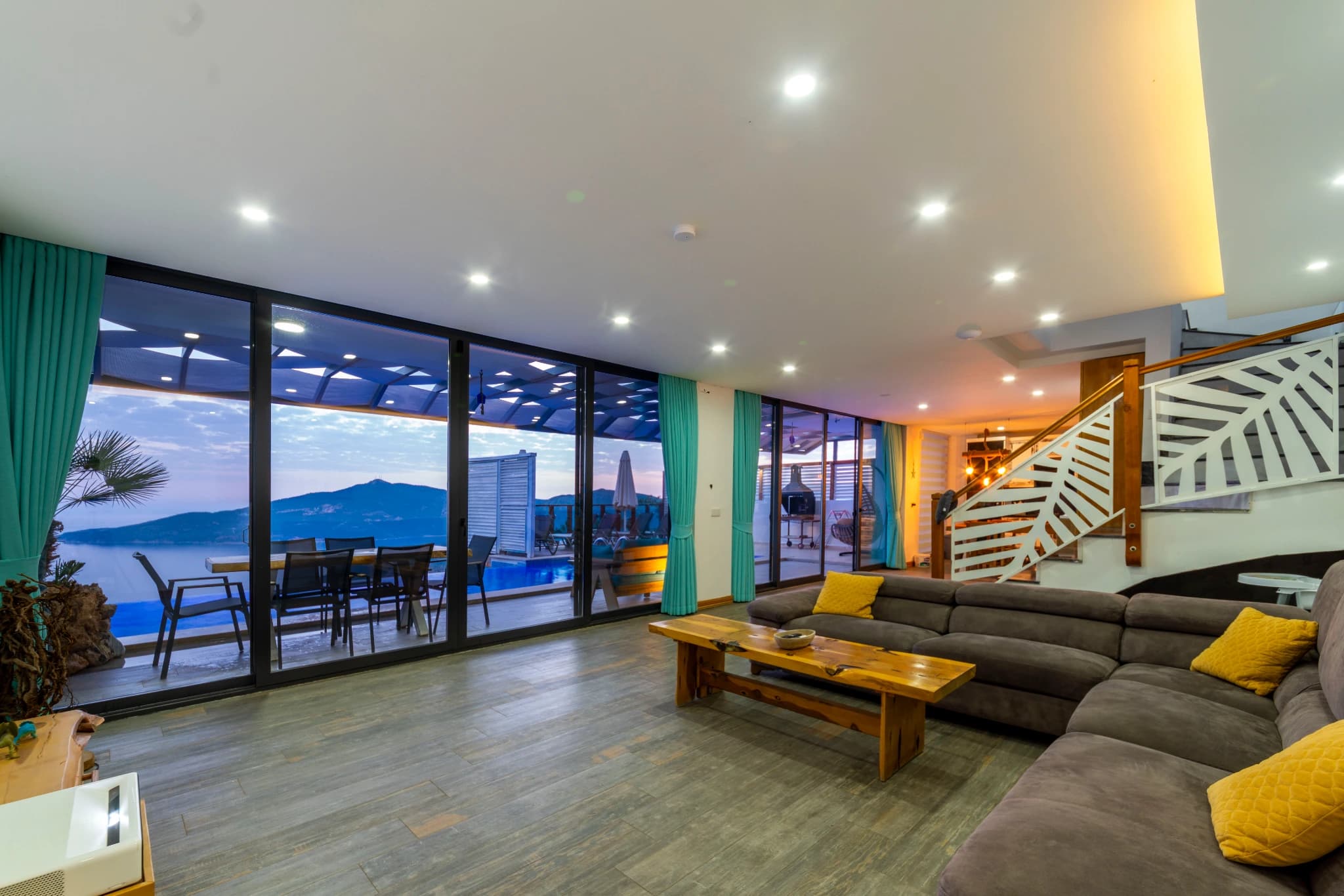 Open-concept living room with comfortable seating and access to waterfront terrace.
