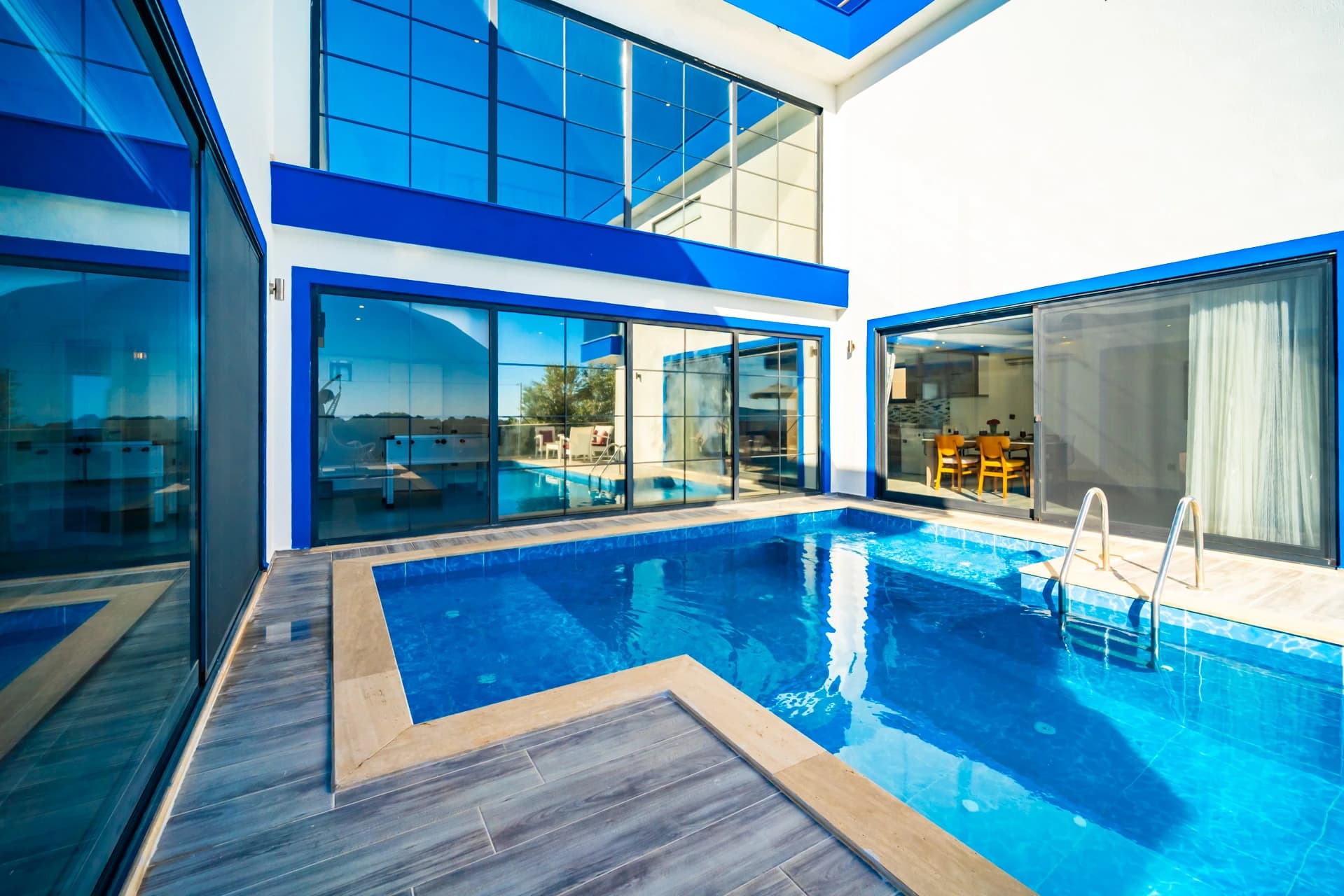 Luxurious indoor heated pool with sea views and contemporary design.