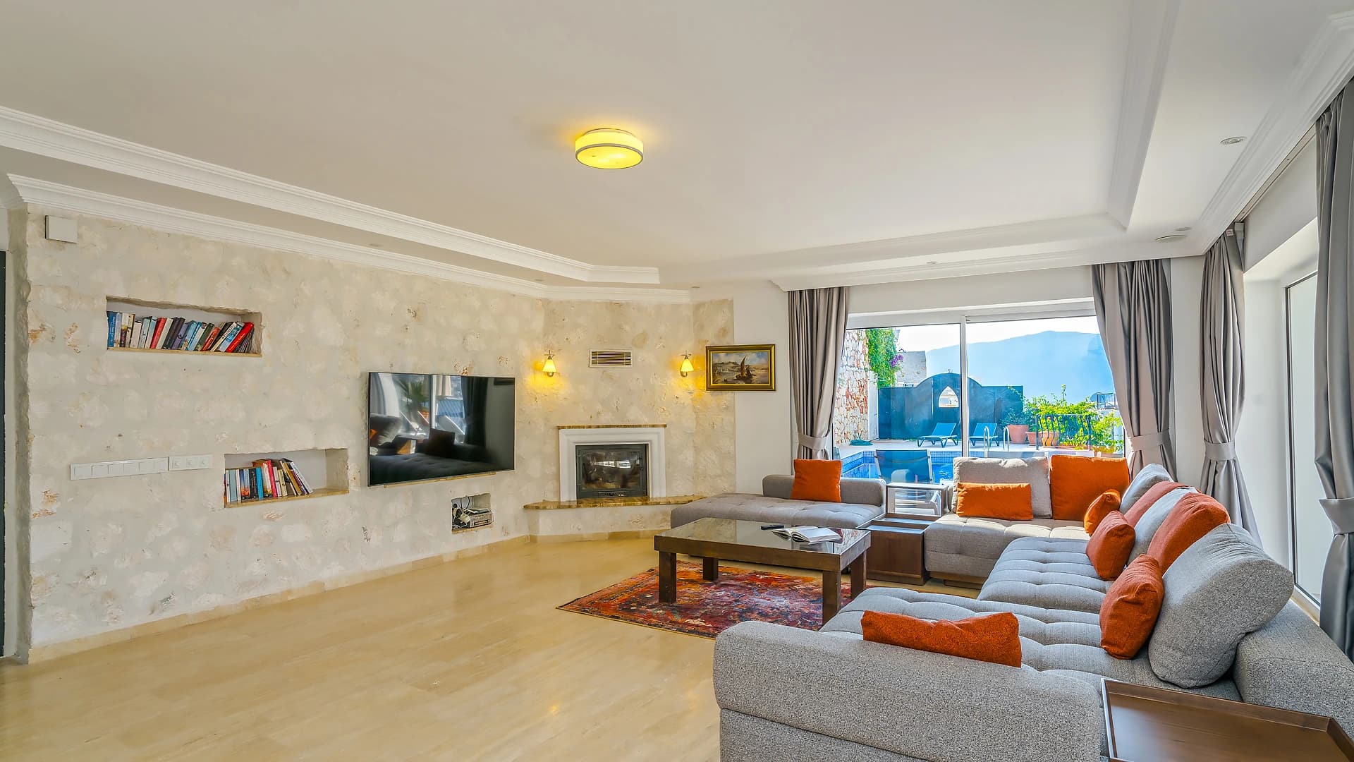 Modern living area with sea views, entertainment system, fireplace, and comfortable seating.