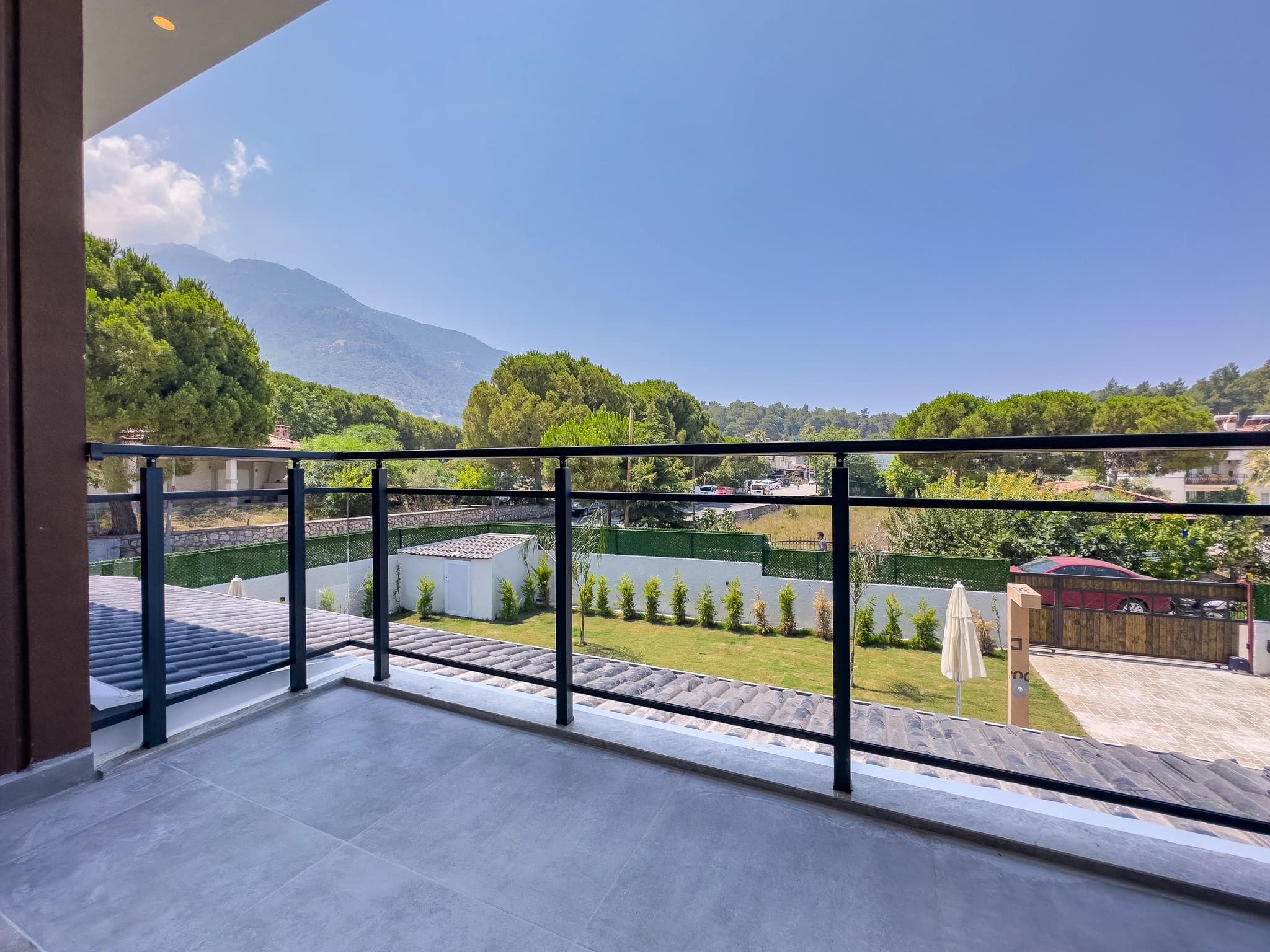 Elevated terrace with stunning mountain vistas, private pool area, and manicured garden with lounging spaces.