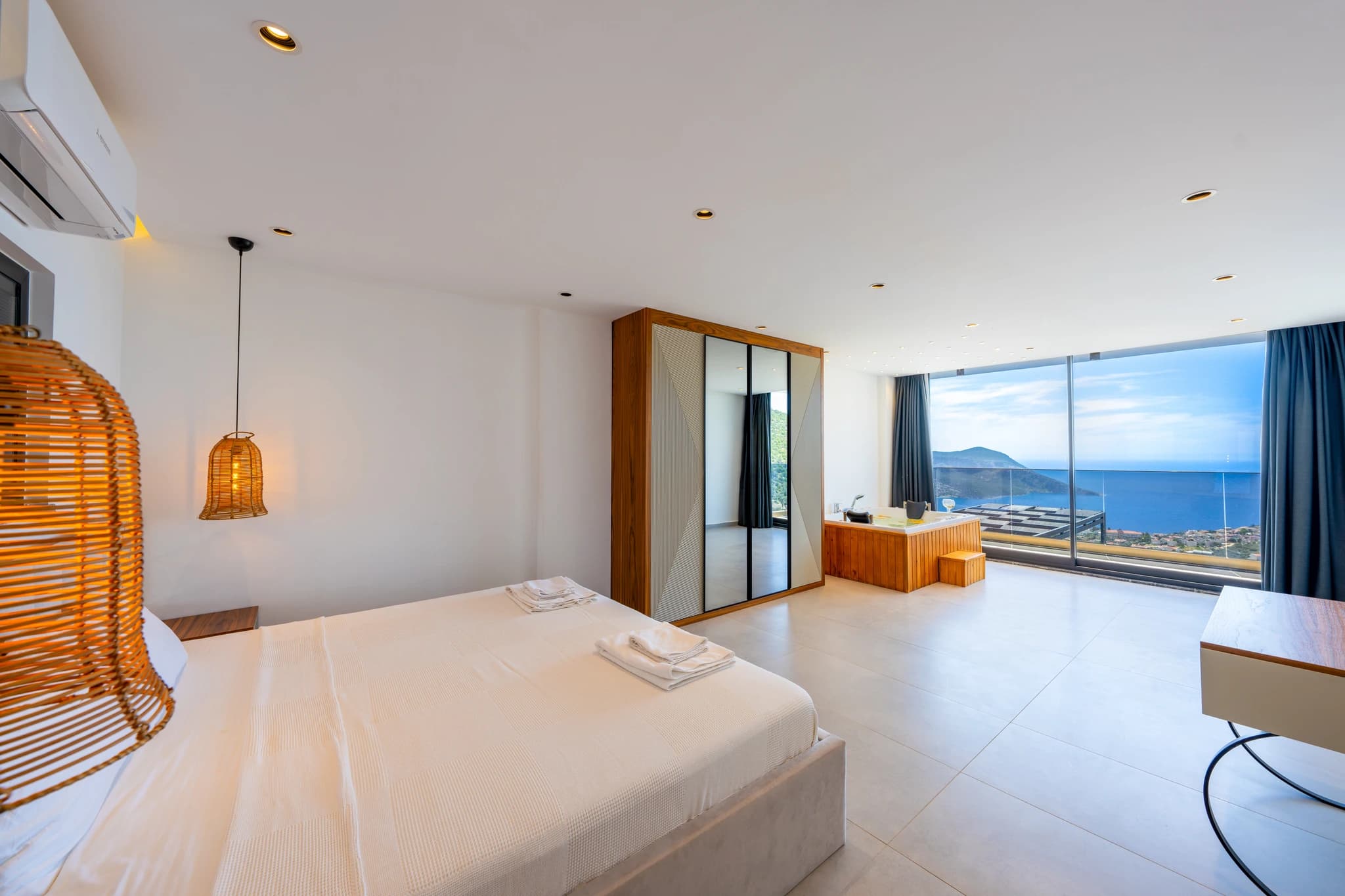 Luxurious master bedroom with panoramic sea views and modern amenities.