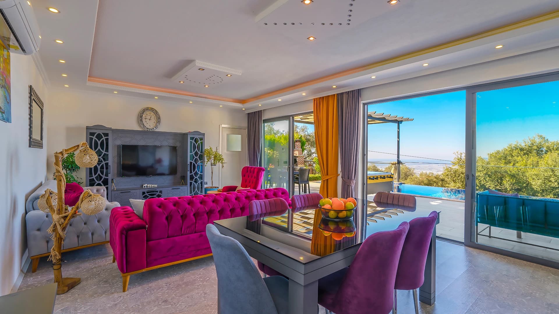 Spacious living room with vibrant furnishings, panoramic sea views, and open terrace access.