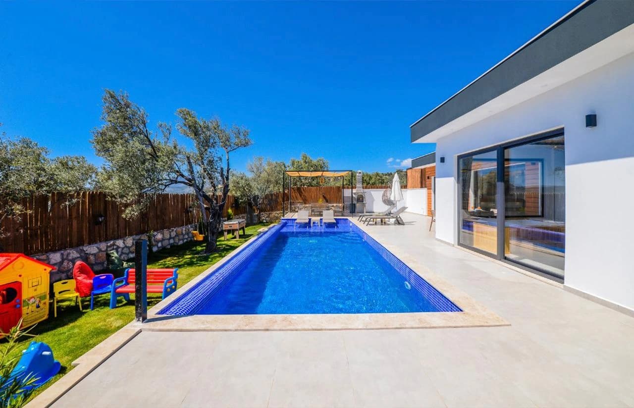 Resort-style outdoor pool with lounging area and family-friendly garden space.