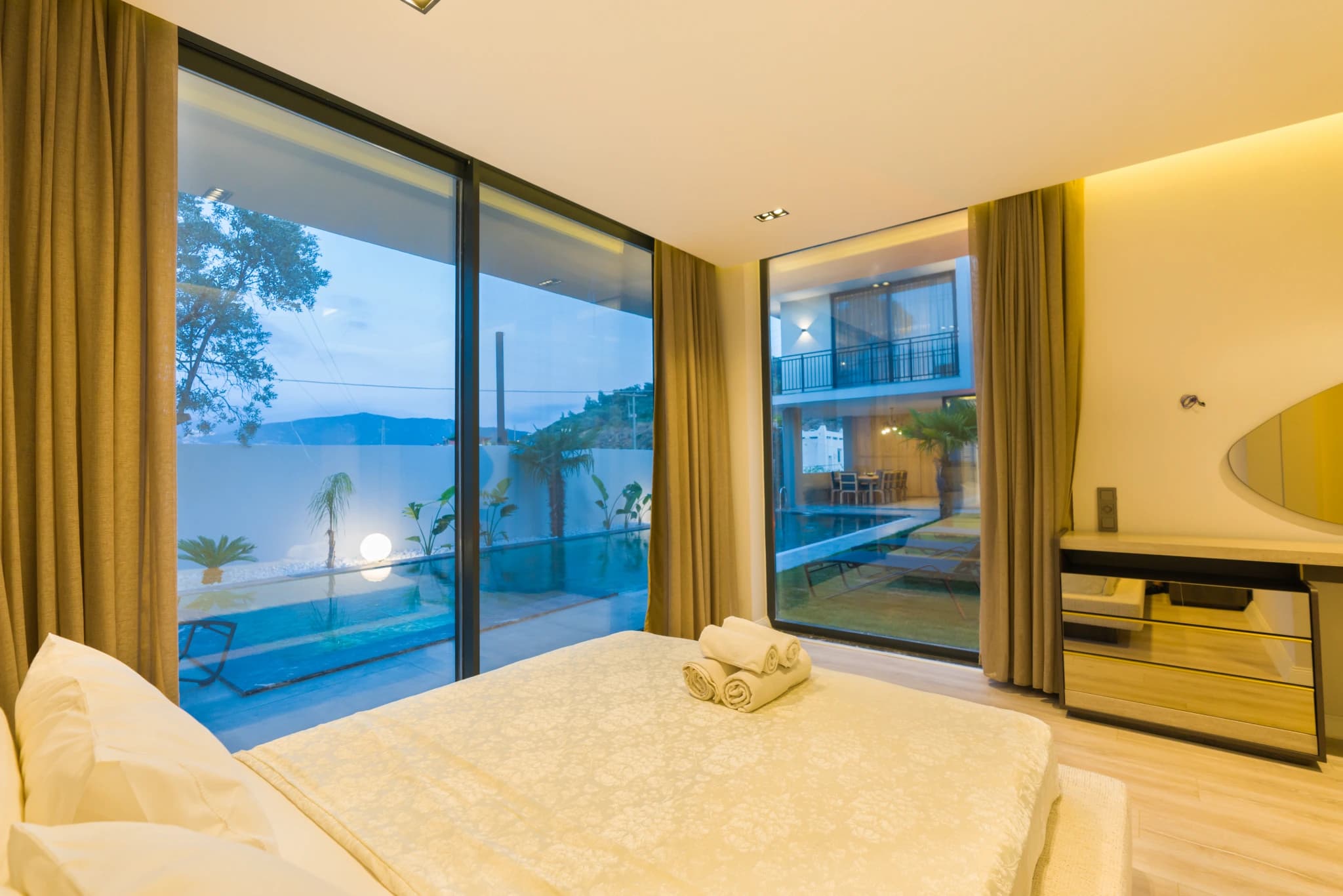 Spacious master bedroom with king bed, sea views, and direct pool access.