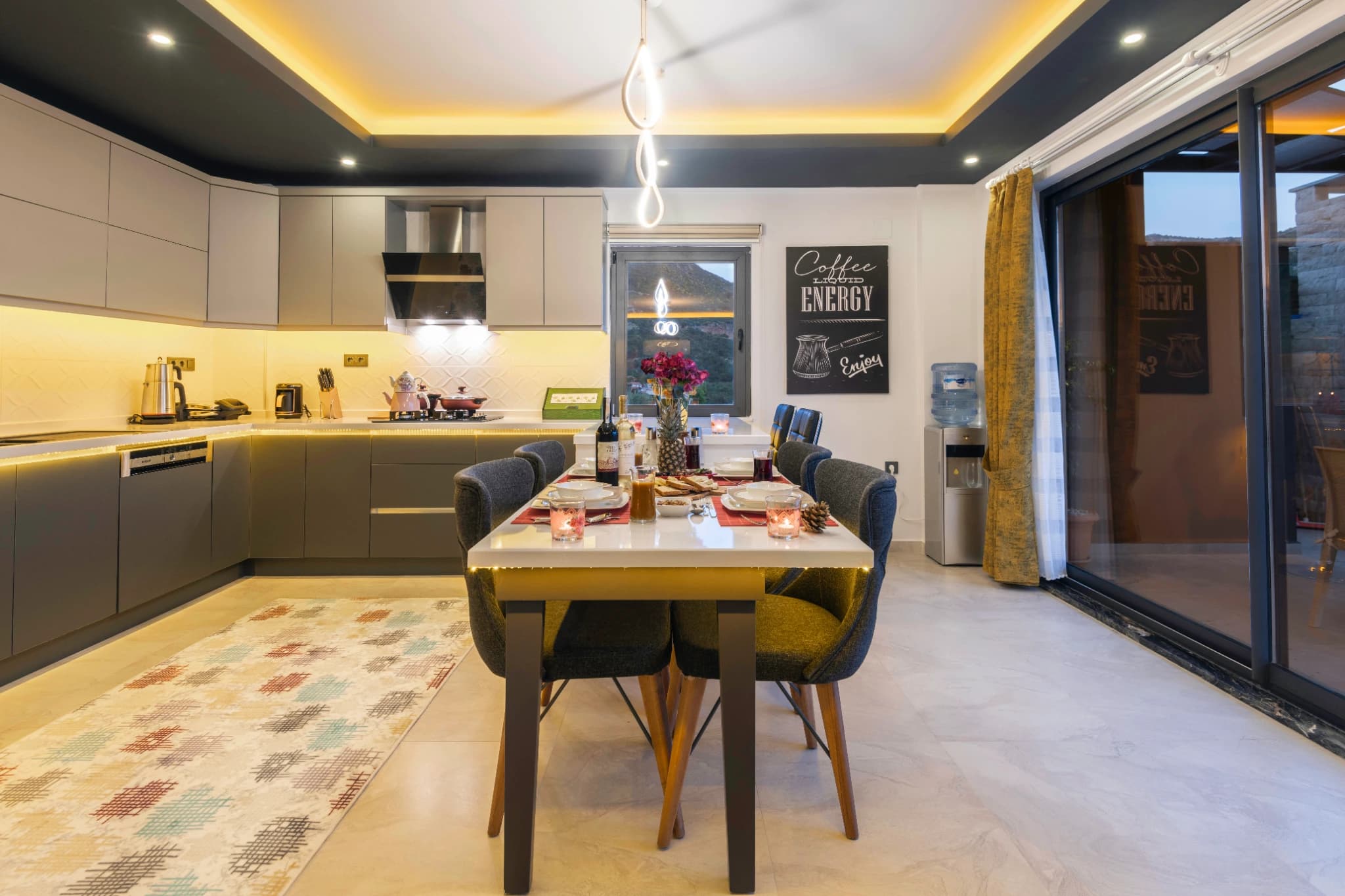 Contemporary kitchen with integrated dining space and outdoor access.