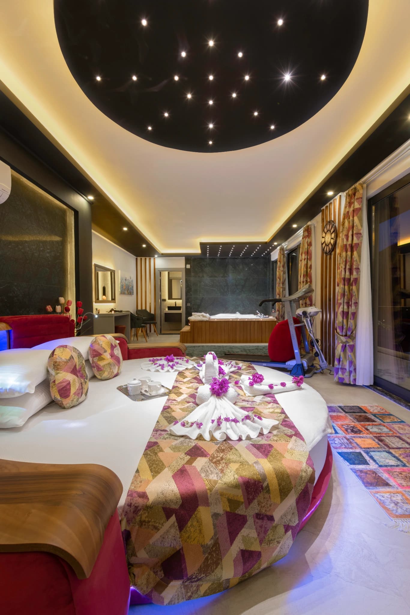 Spacious bedroom suite featuring a king bed with in-room jacuzzi bathtub.