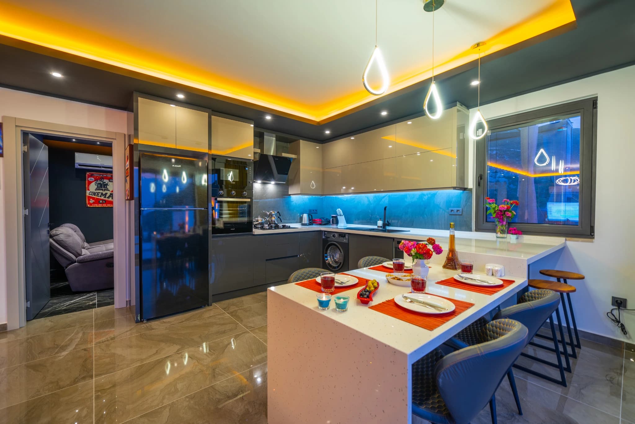 Contemporary kitchen with island counter and integrated dining area.