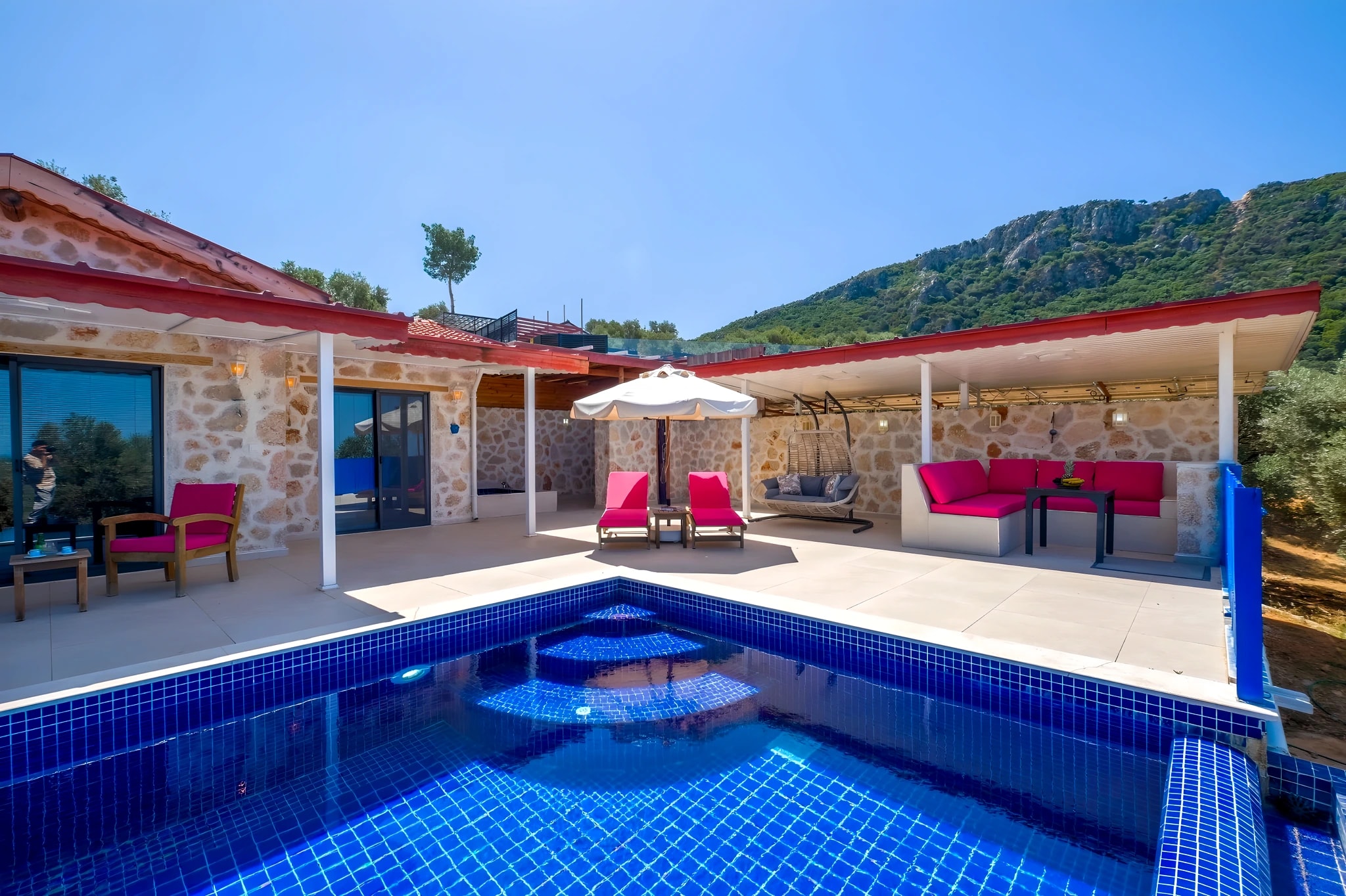 Stunning pool area with vibrant seating and scenic mountain backdrop.