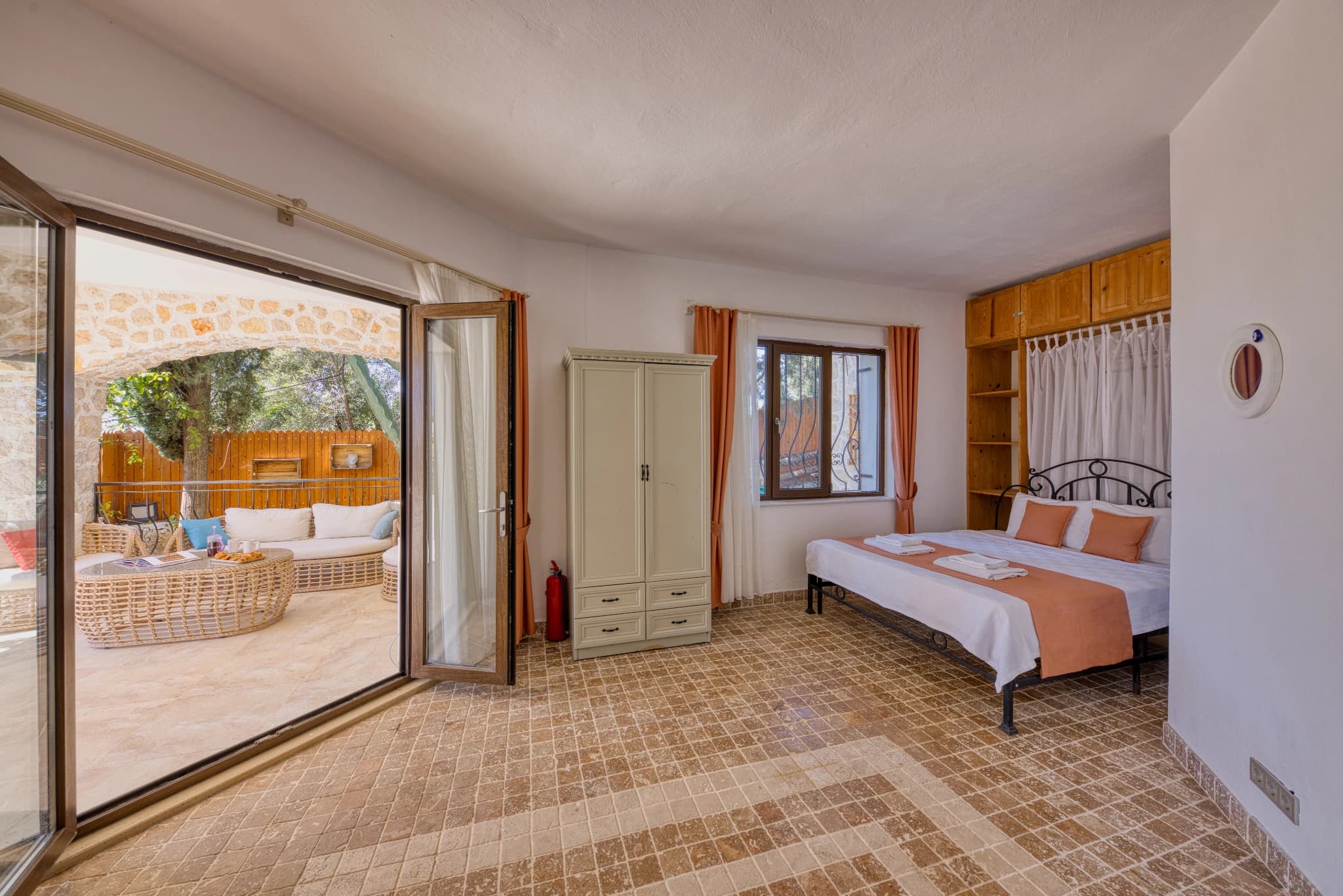 Bright bedroom with queen bed and direct access to private terrace and garden.