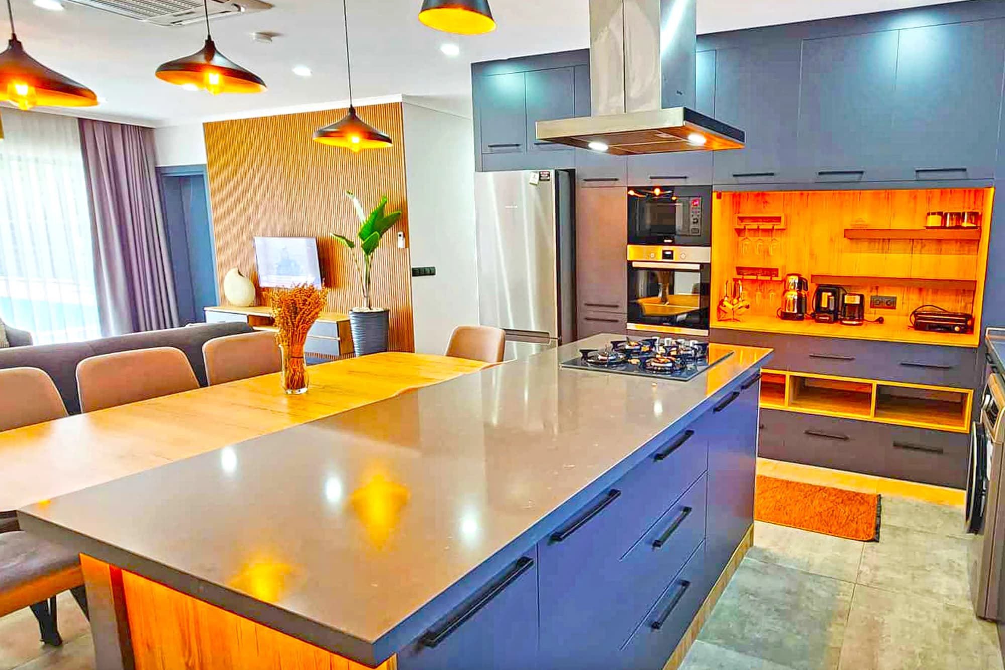 Contemporary open-plan kitchen with island, gas cooking, and breakfast seating.
